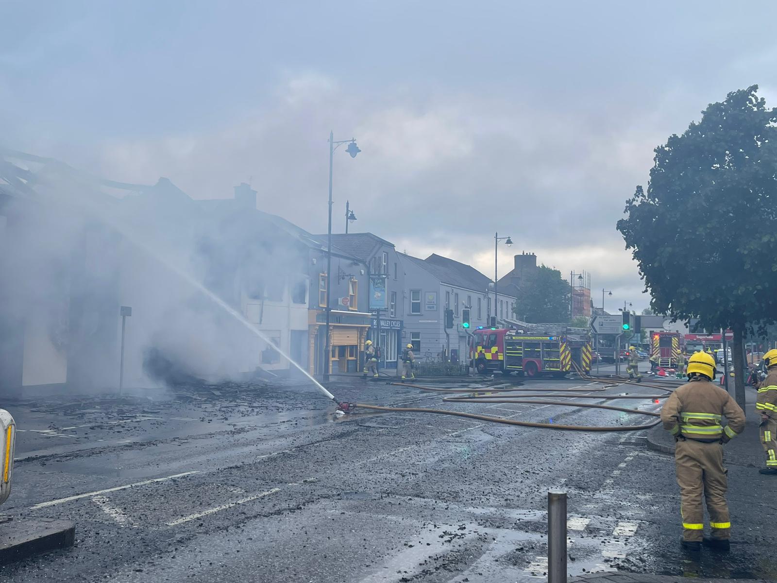 Firefighters survey a fire in a commercial premises in Limavady after extinguishing the blaze.